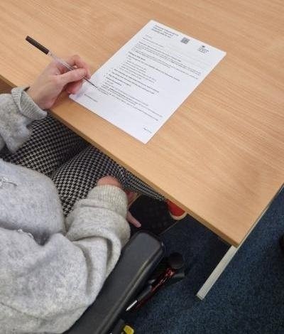 Disabled woman in wheelchair filling out an application